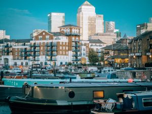 London Airbnb boat in Limehouse Basin with Canary Wharf in the background - Written From Travel